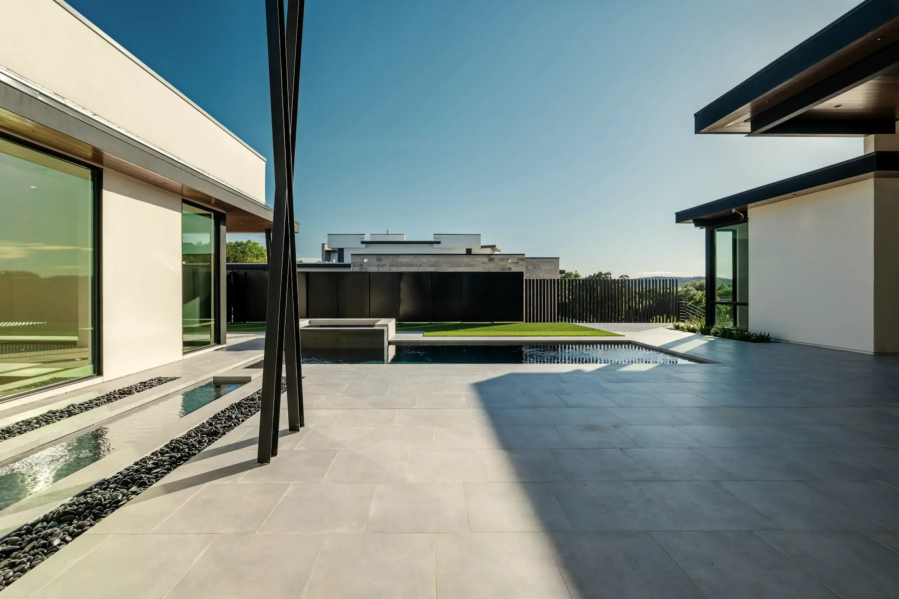 The west terrace looking out over the pool to the hill country beyond the boundary.
