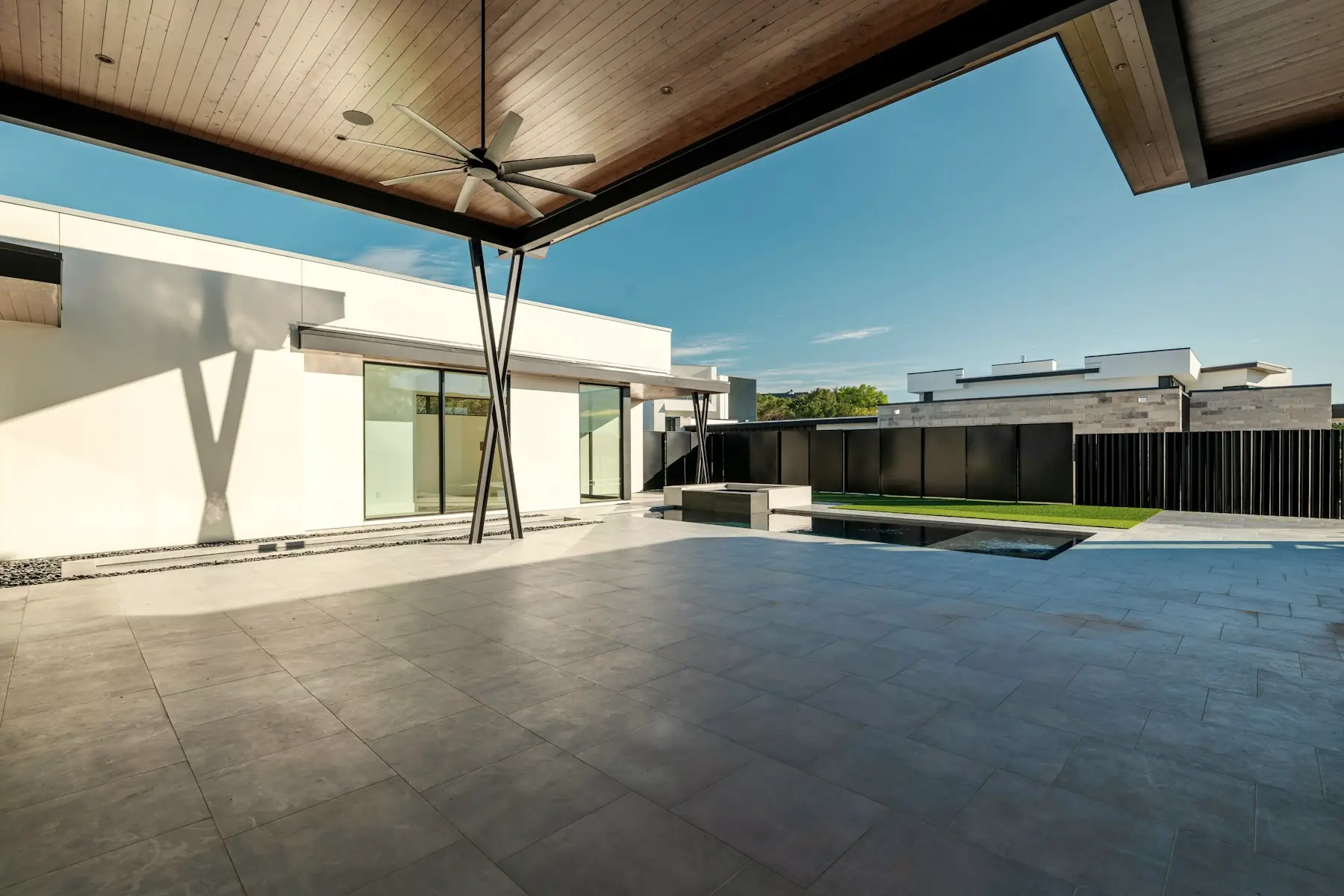 The covered terrace between the two wings, with the courtyard beyond.