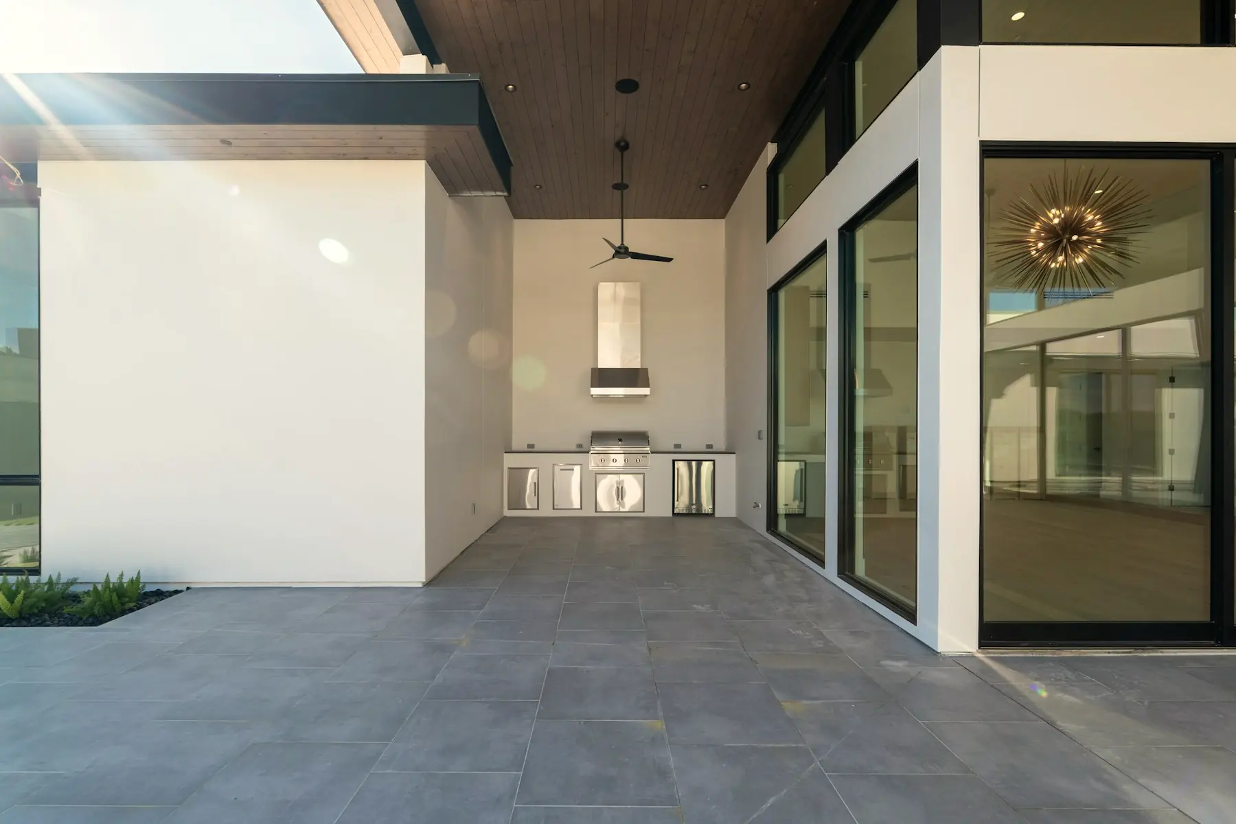 The outdoor kitchen built into the terrace wall under the main roof.